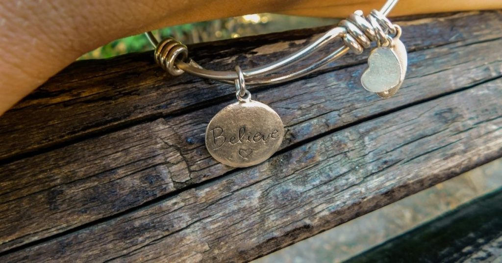 bracelet with "believe" engraved on it