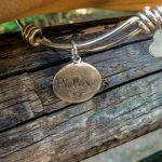 bracelet with "believe" engraved on it